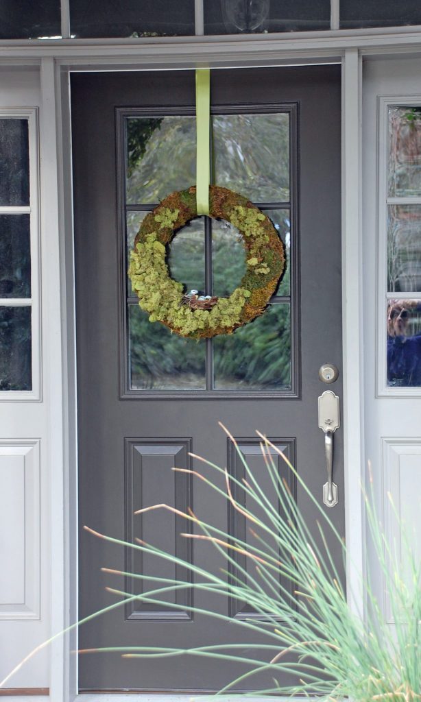 DIY Spring Wreath: finished moss wreath hanging outside on front door