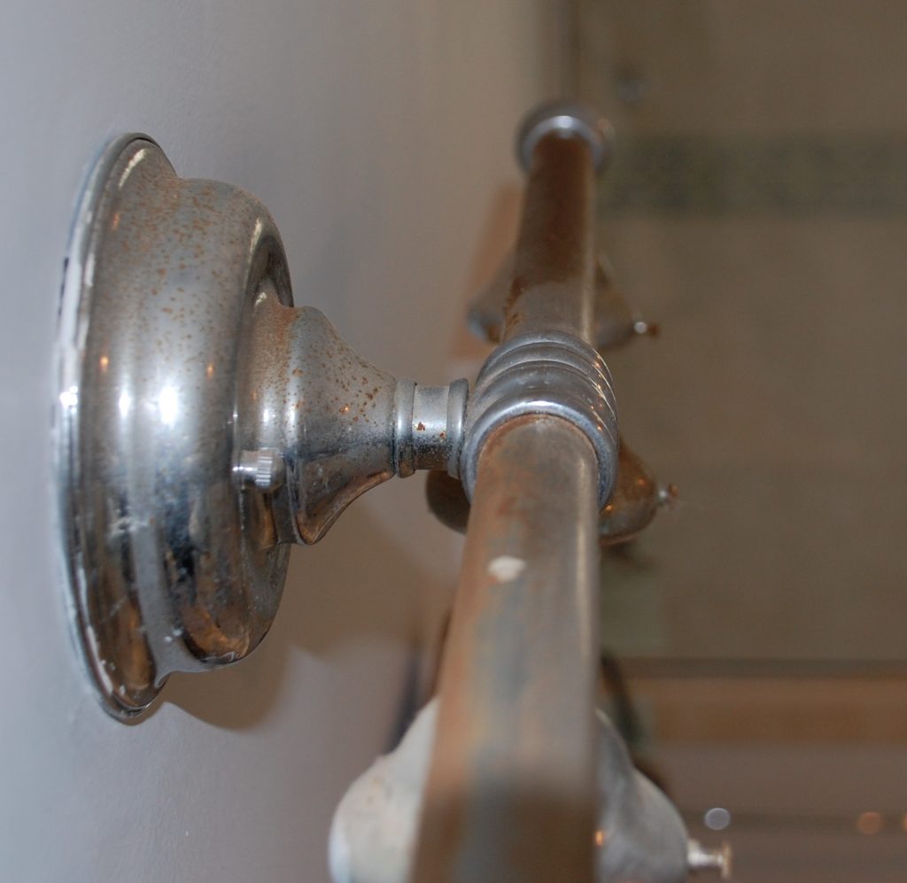 close up of rust on bathroom light fixture