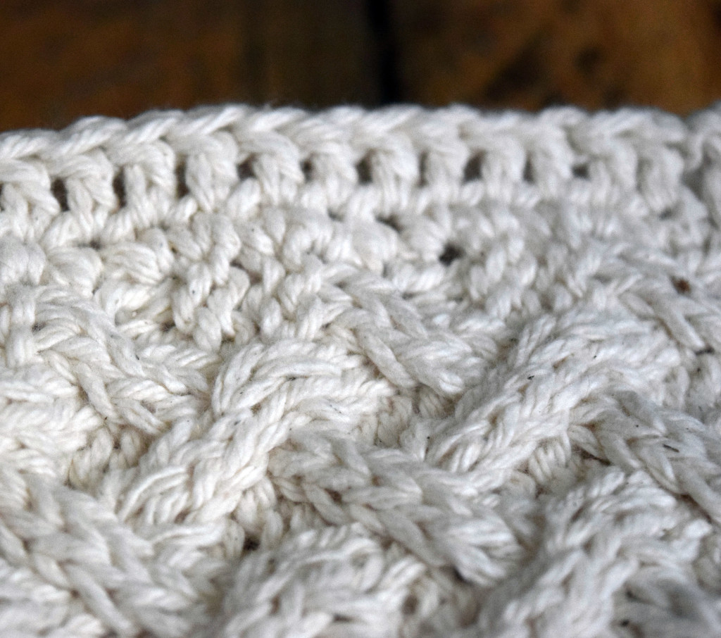 close up showing crochet edge of knit cotton washcloth with lattice stitch