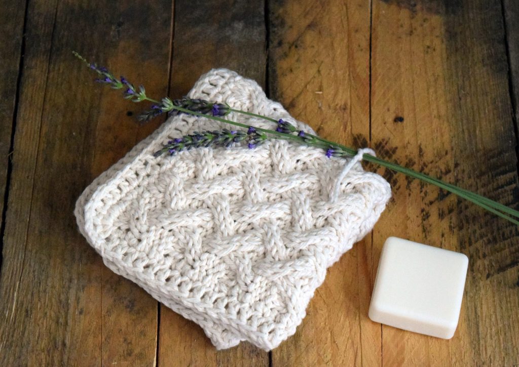 Knit cotton washcloth with lattice stitch and crochet edge