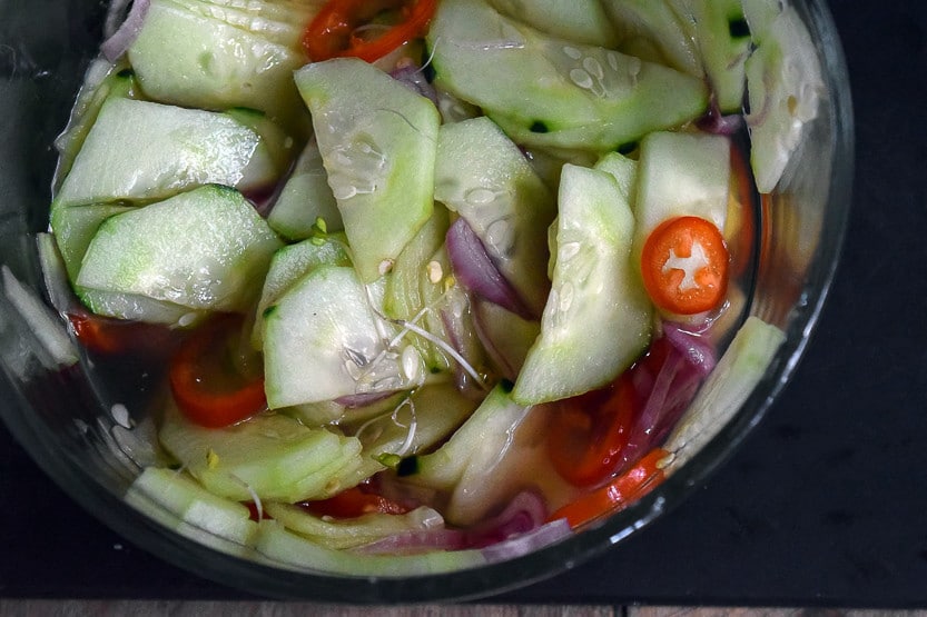 Satay chicken rice bowl recipe with spicy asian cucumber salad - close up of cucumber salad