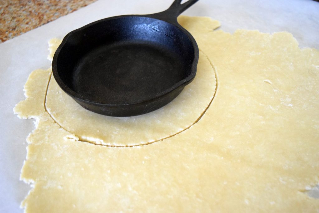 Individual cast iron skillet pecan pie recipe: cutting pie crust using mini iron skillets for size