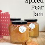 Jars of Rum Spiced Pear Jam with a little jam on a scone
