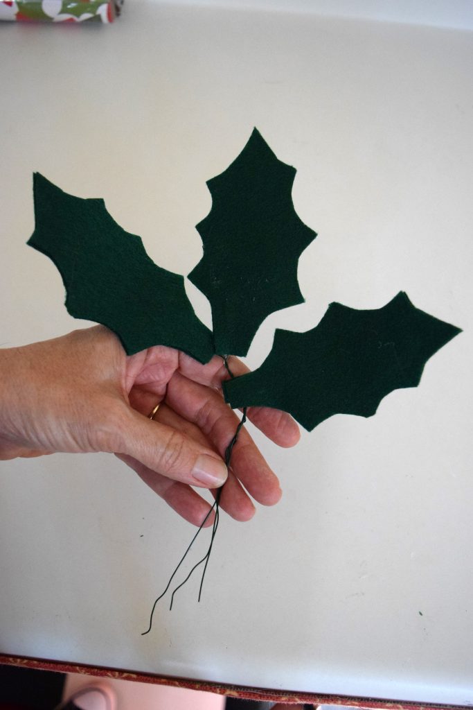 Felt Holly Leaf Garland. Simple felt, some glue and wire come together as different twist on traditional garlands. At www.nourishandnestle.com