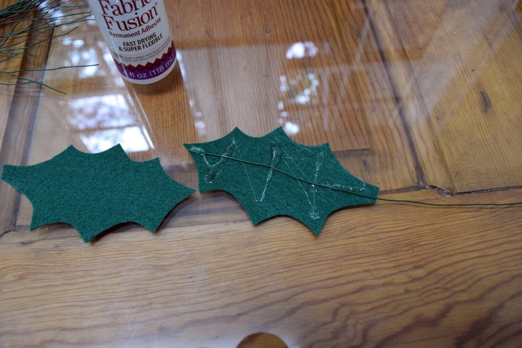 Felt Holly Leaf Garland. Simple felt, some glue and wire come together as different twist on traditional garlands. At www.nourishandnestle.com