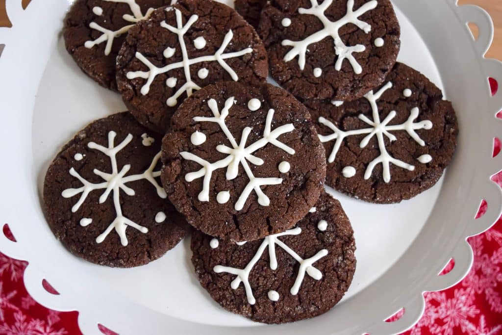 Dutch chocolate cookies with snowflakes drawn in icing.
