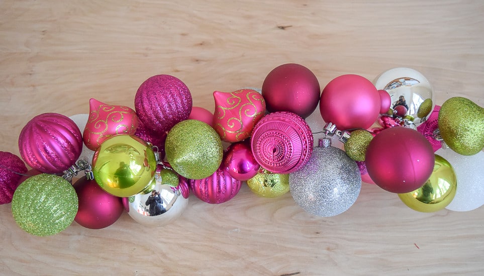 Dress your front porch for the holidays. Instructions and illustrations to make a DIY Ornament Garland with plastic ornaments, coiled wire and florist wire.