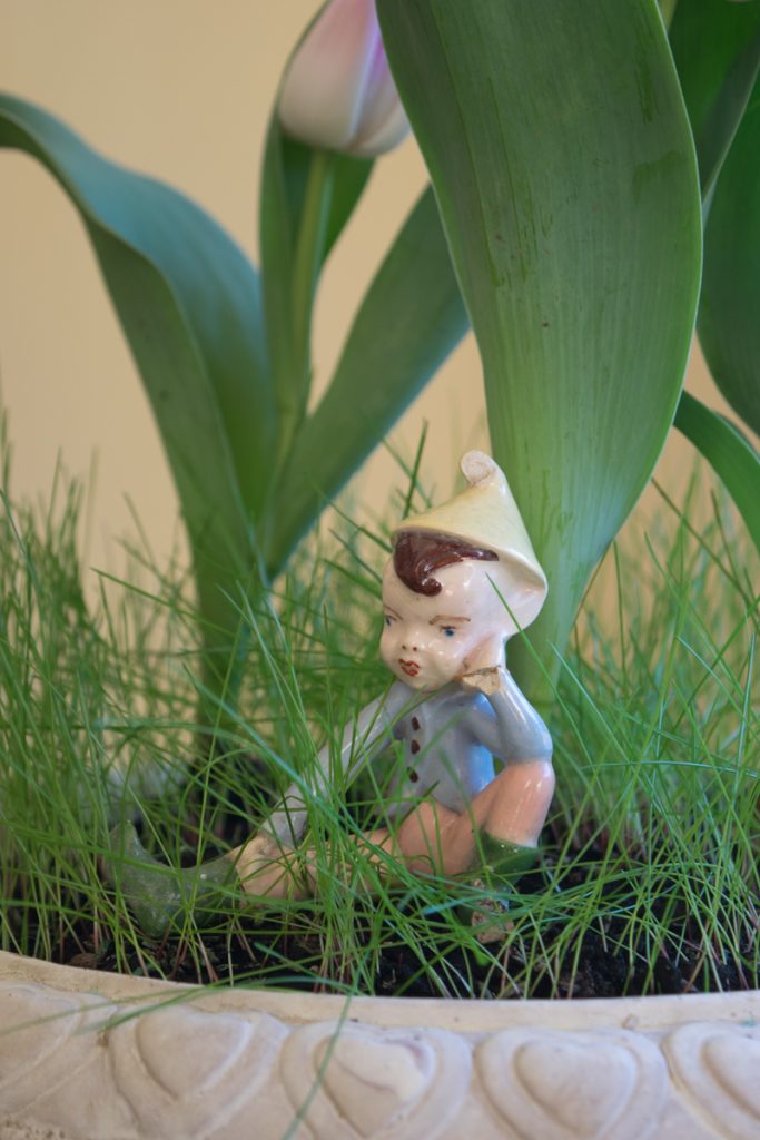 Spring Decor Ideas: Close up of porcelain elf in tulip planter