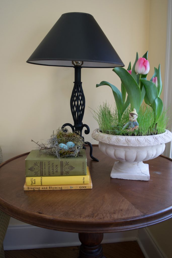 Spring Decor Ideas: Nest with bird eggs next to tulip planter on end table