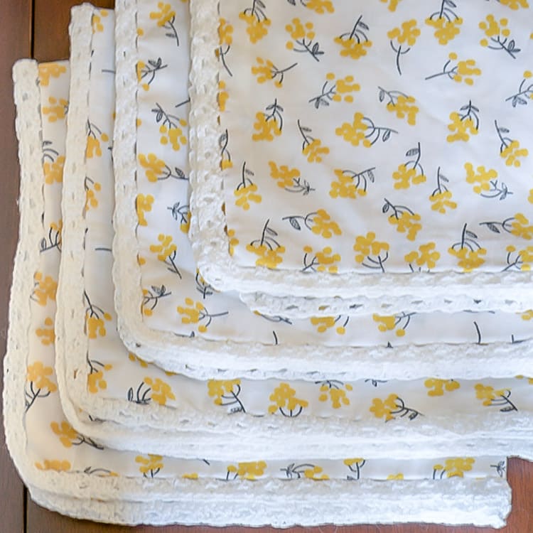 A stack of easy to make napkins with mitred-corners and crochet edge.