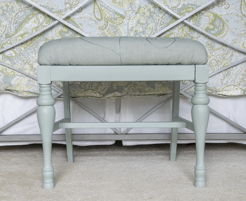 A little paint and some embroidered linen fabric transform a sad little bench into a real beauty. An easy DIY home decor project with step by step instructions.