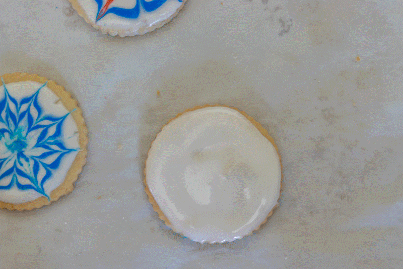 Gif showing how to paint red white and blue cookies.