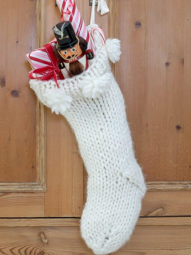 Christmas Stocking with nutcracker and presents tucked in.
