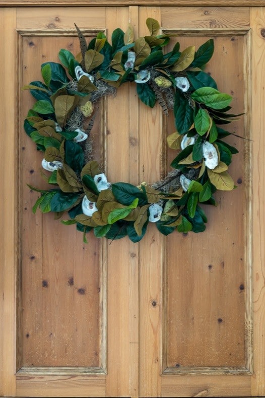 Illustrated instructions to make a fall wreath using oysters, magnolia leaves, magnolia seed pods and pheasant feathers. Perfect decor for your front porch.
