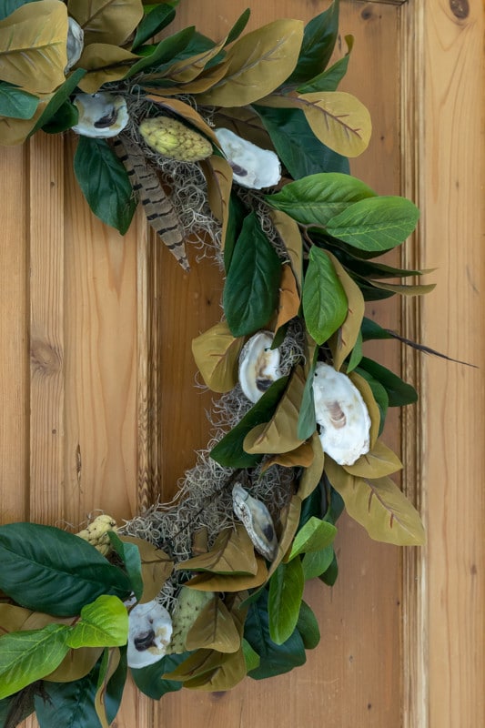 Illustrated instructions to make a fall wreath using oysters, magnolia leaves, magnolia seed pods and pheasant feathers. Perfect decor for your front porch.