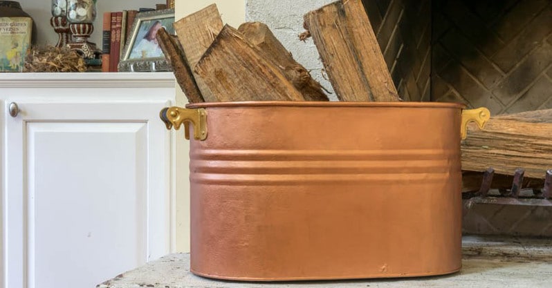 Copper tub with logs.