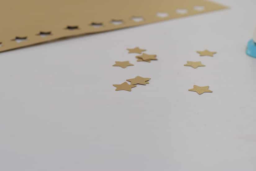 using hole punch to make gold stars as tree toppers