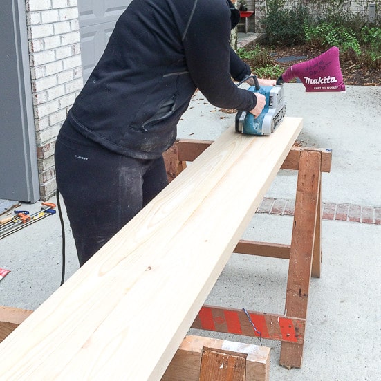 How to build a console table: Using belt sander to sand table top