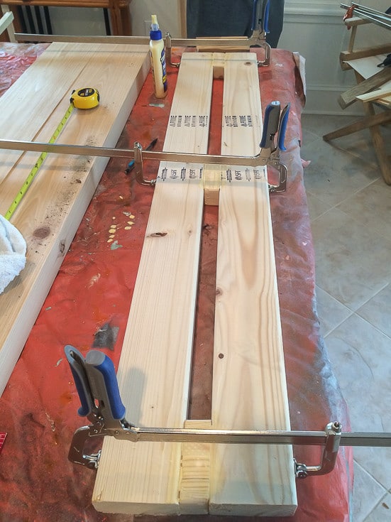 DIY Console Table: base of table being glued - held together with Kreg clamps