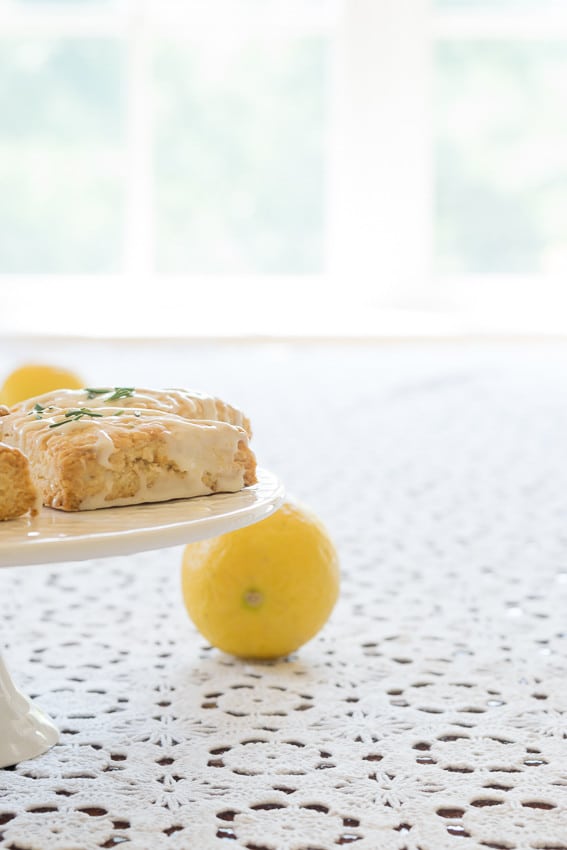 A easy and reliable recipe for light, tender and crumbly Lemon Rosemary Scones with a lemon glaze; perfect for breakfast, tea, snack or dessert.