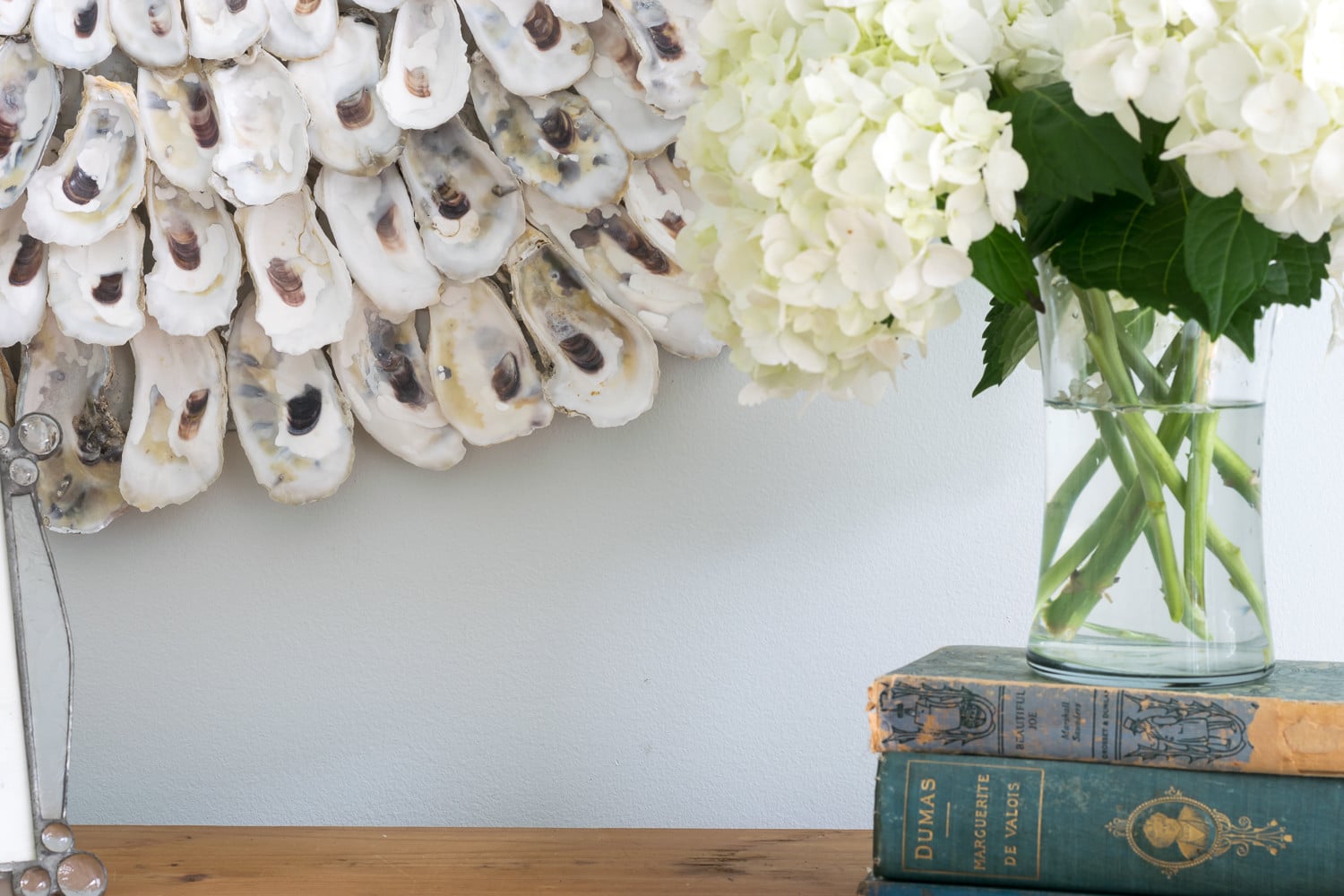 This DIY Oyster Shell Mirror is so easy to make and adds instant charm to your home decor. Not only perfect for coastal decor, but suitable for other decor styles as well. 