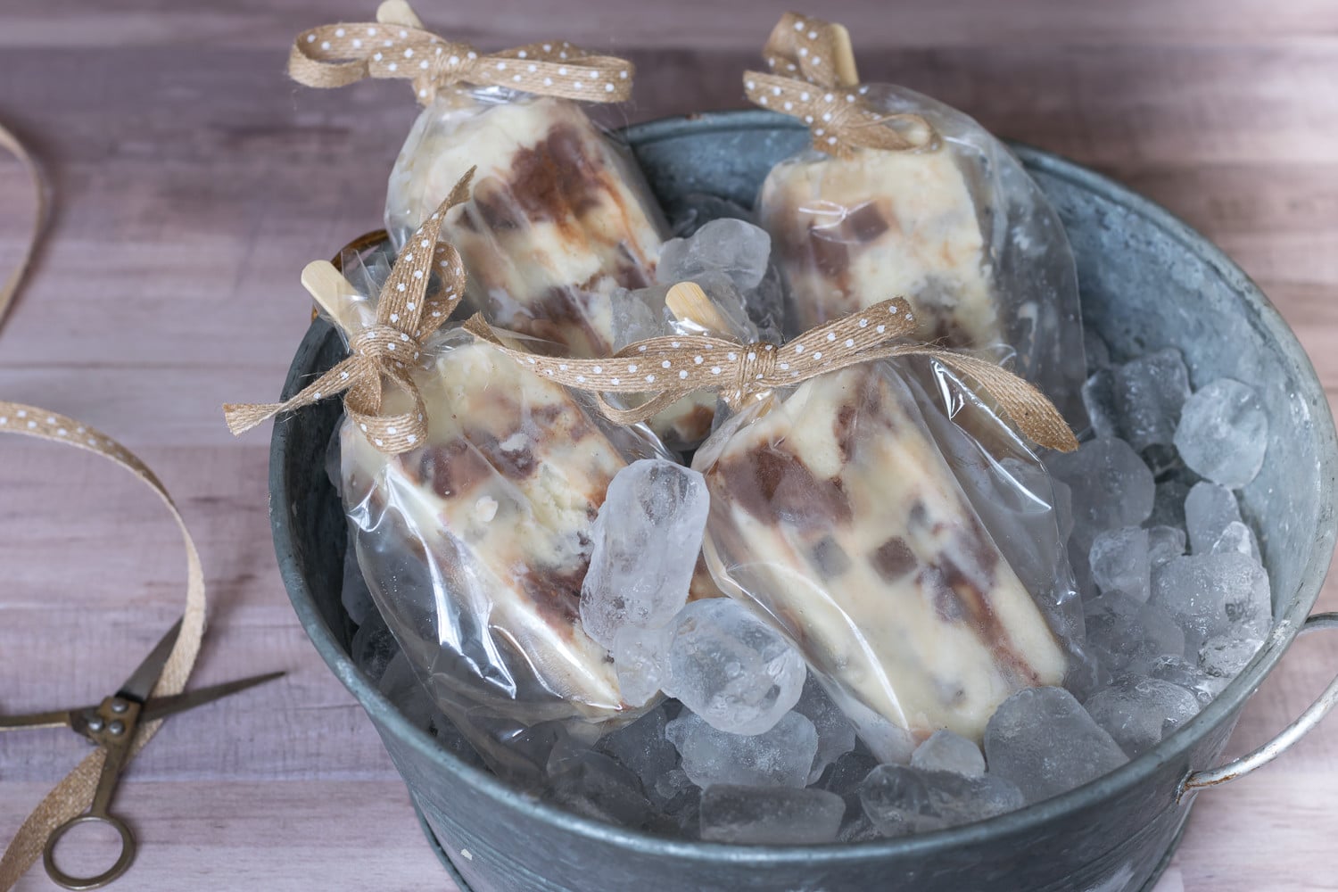 Need a fun dessert for your next gathering? Try these Popsicles made with vanilla ice cream, chocolate ribbons and iced coffee cubes. 