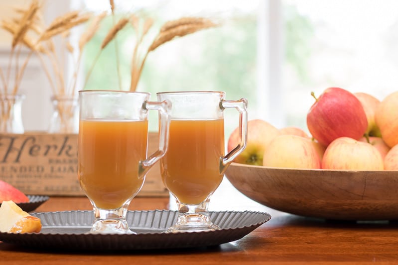 This spiked warm caramel apple cider is like a cup of fall! Perfect adult beverage recipe for tailgating, entertaining or sipping around the fire on a cool fall evening