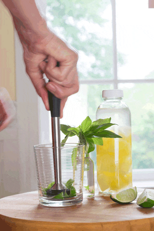 Muddling Pineapple Sage, Limes and Simple Syrup for the Pineapple Sage Mojito. Get the recipe and tips on the post. #cocktails #recipes #muddling #mojito #pineapple sage #herbs