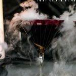Black Widow Martini Cocktail with smoke coming out of glass