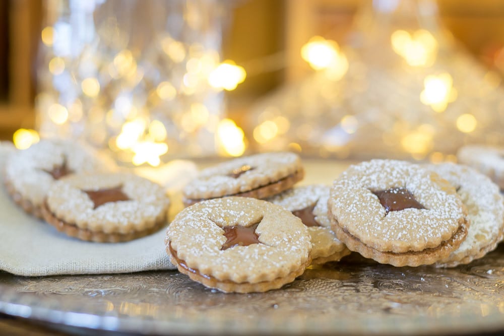 Holiday baking schedule and recipes: beautiful spiced linzer cookies with pear filling on a platter