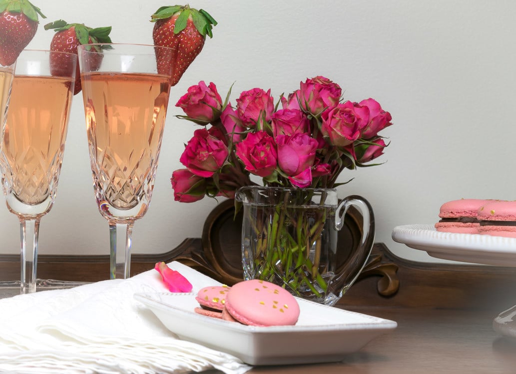 Valentine Strawberry Prosecco Cocktail: served with roses, a strawberry garnish and pink french macarons 