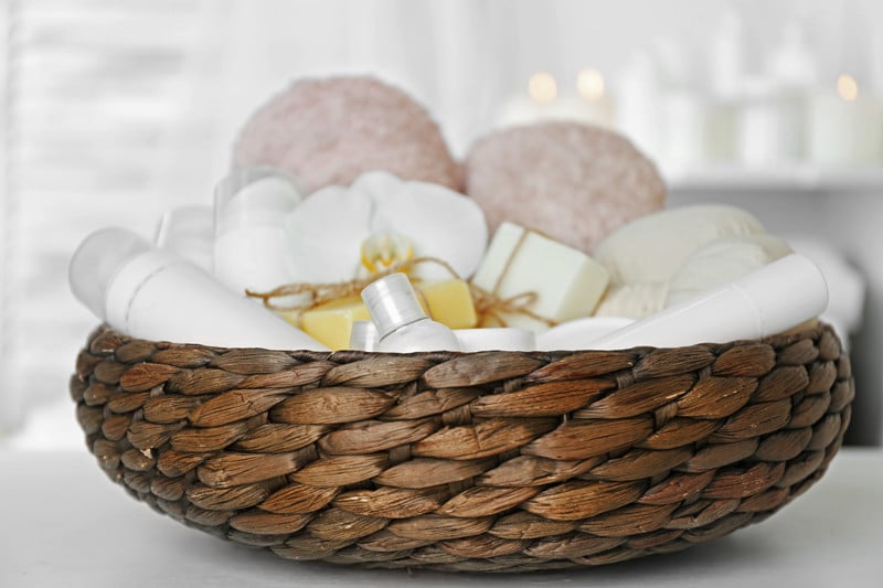 Wicker basket with spa treatments on table