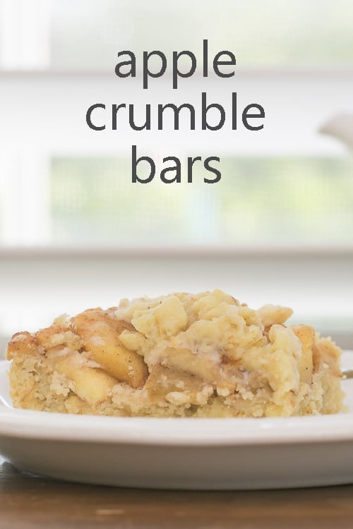 Pin showing Apple Crumble Bars on a Plate in front of a window
