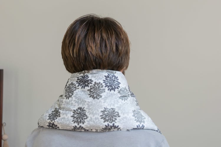 A person standing in a room, with Heating Pad
