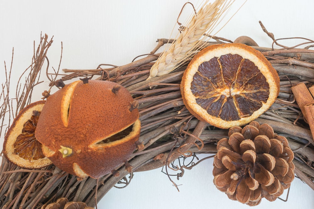 Dried Whole Oranges and Orange Slices, PInecones and Wheat Sheaves on the Fall Kitchen Wreath.