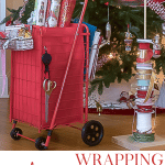 DIY Wrapping Paper Organizer filled with paper and in front of Christmas Tree