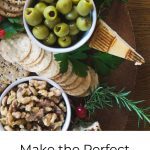 Overhead shot of Holiday Charcuterie Board with cheese, olives and rosemary walnuts.