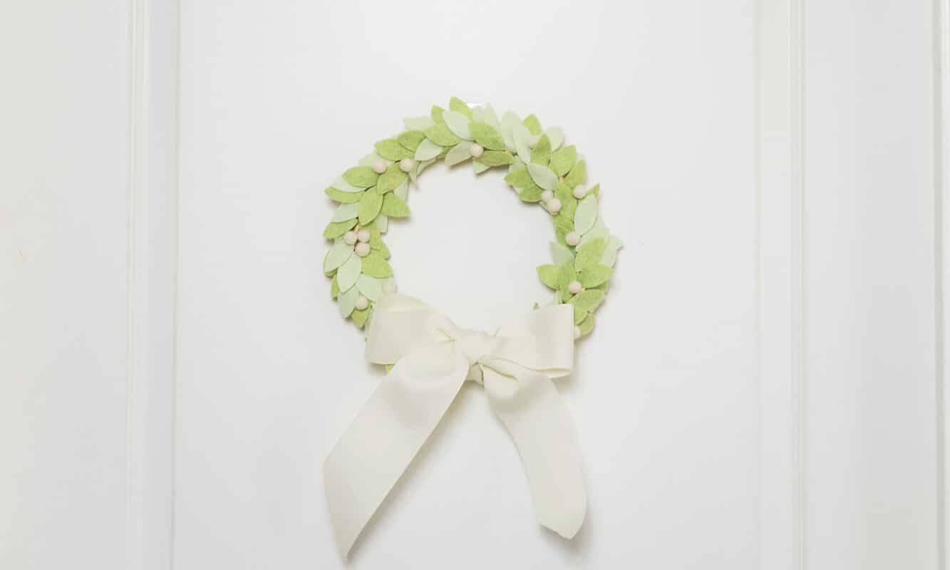 Use wreaths to help decorate small space for Christmas. This felt leaf wreath with white berries would be perfect