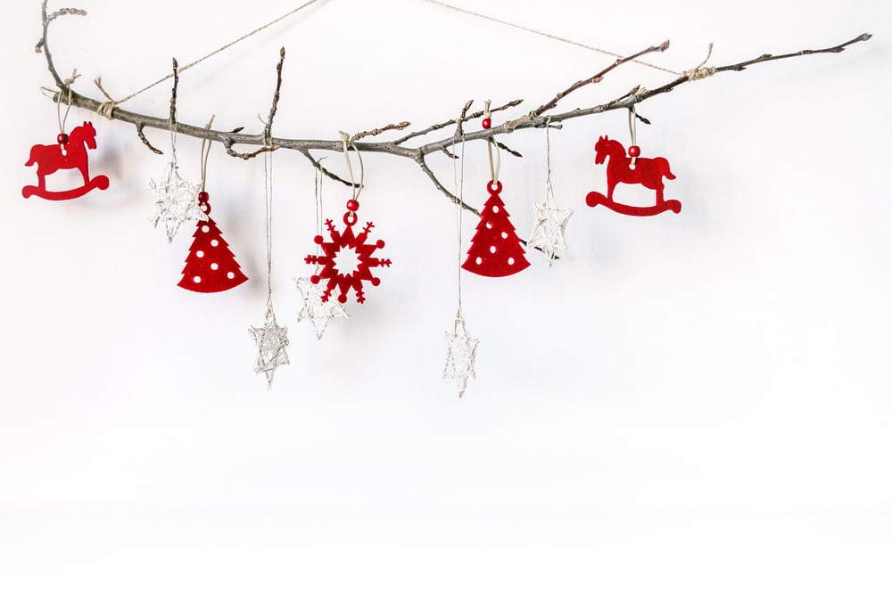 A branch with red and white Christmas decorations is great when decorating a small space for Christmas