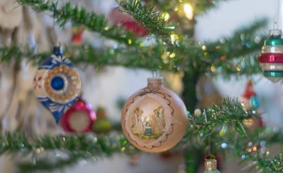 A close up of a christmas tree and ornament.