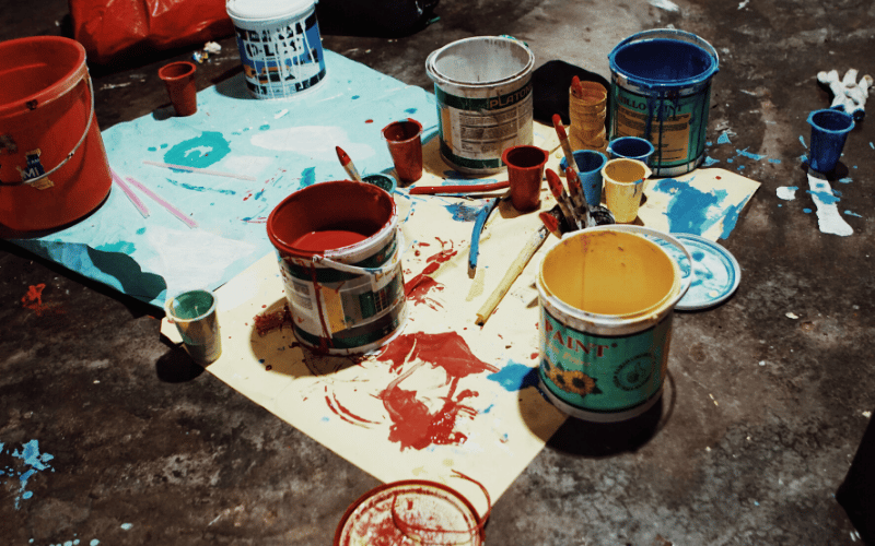 Paint cans and spilled paint.