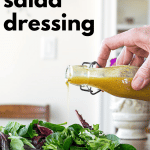 Pouring Curry Salad Dressing over Greens