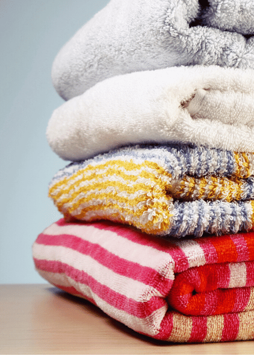 stack of towels to discard using the Declutter Your Home Checklist