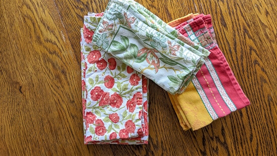 An assortment of reusable cloth napkins. One of the suggested eco-friendly products for a more sustainable kitchen.