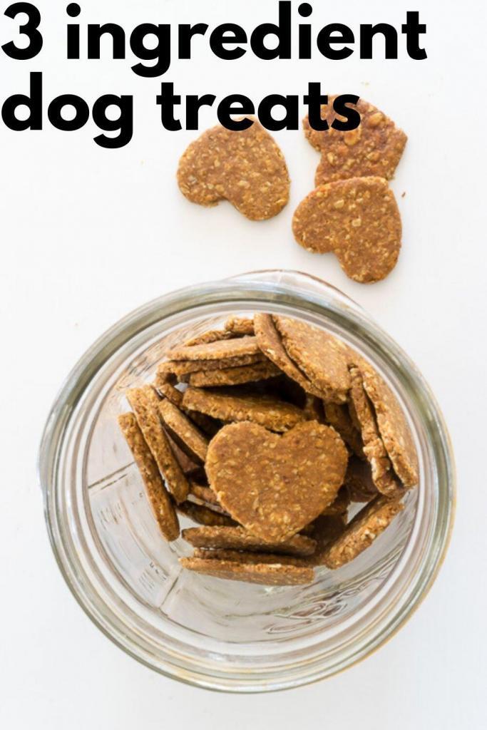 Heart-shaped dog treats in a jar and on a counter.