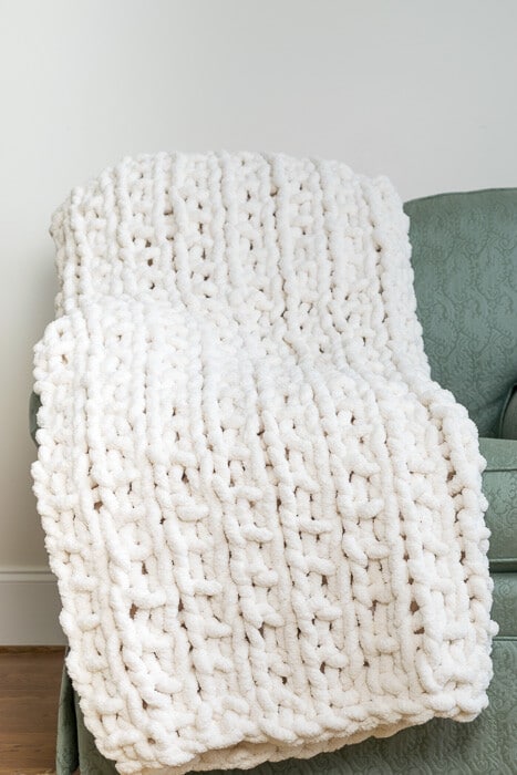 Linen stitch blanket with faux fur trim.