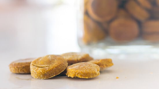 Homemade Pumpkin Dog Treats: Dehydrated dog treats spread out on counter