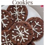 Overhead shot of a plate of Chocolate Christmas Cookie decorated with snowflakes