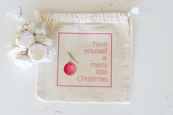 Bag of Amaretti Cookies with a gift bag that says, 'have yourself a Merry Little Christmas'
