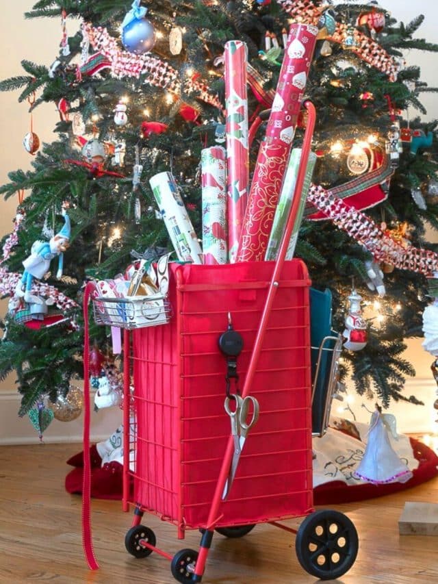 DIY Wrapping Paper Organizer filled with paper and in front of Christmas Tree